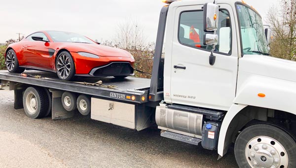 sports car on flat bed tow truck